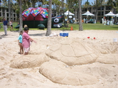 Sand scupture, inflatable turtle, and booth